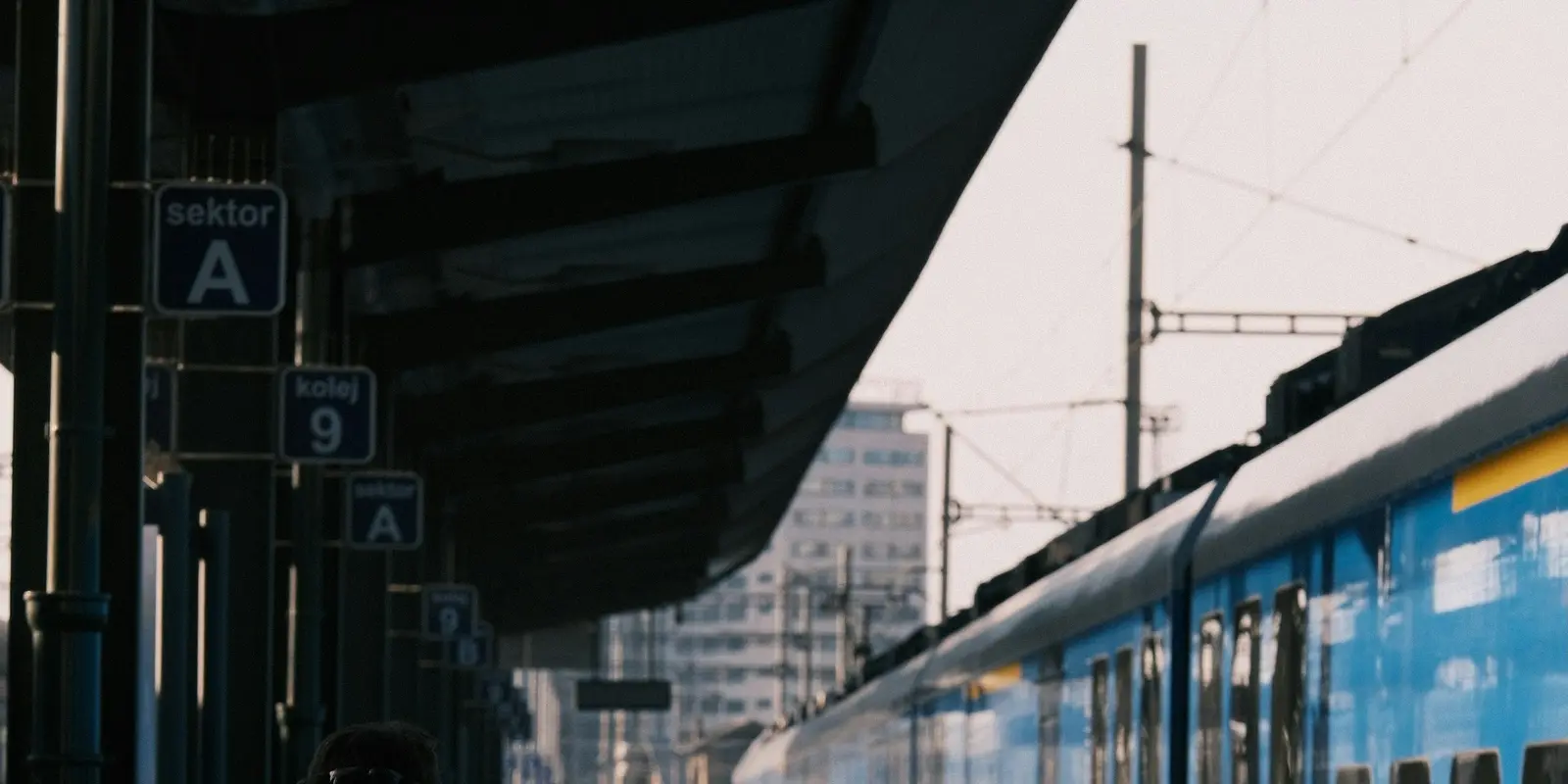 Border-hopping by train is where a regional eSIM earns its cost Traveler with a backpack on a European train station platform
