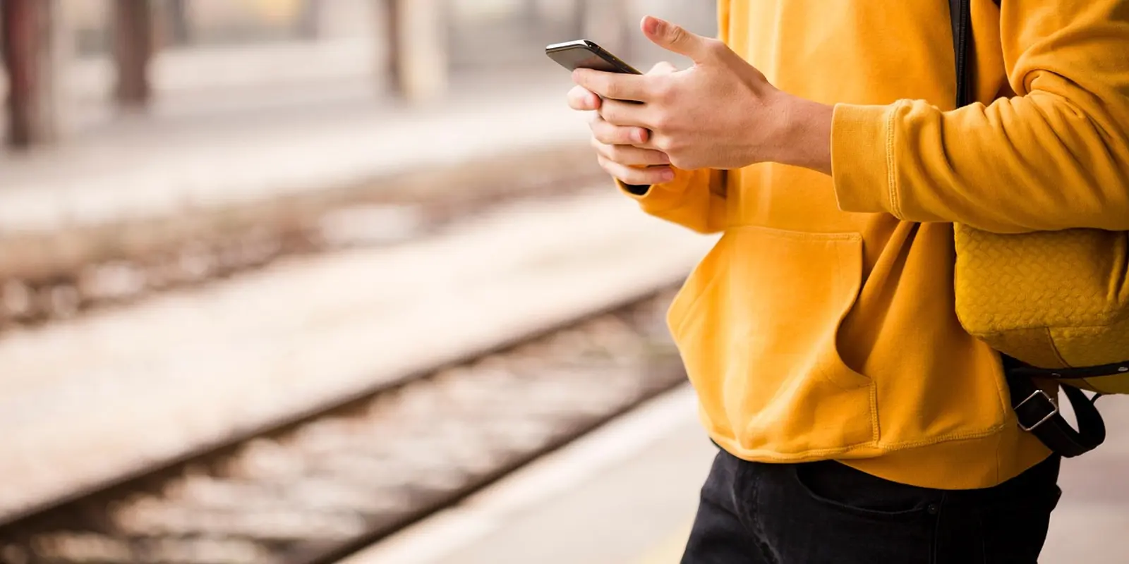 Traveler checking rail directions on a smartphone at a Tokyo train station