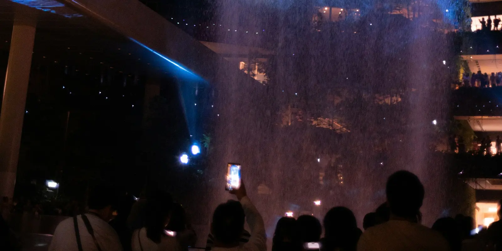 The Rain Vortex at Jewel Changi Airport Jewel Changi Airport's indoor Rain Vortex waterfall lit up at night