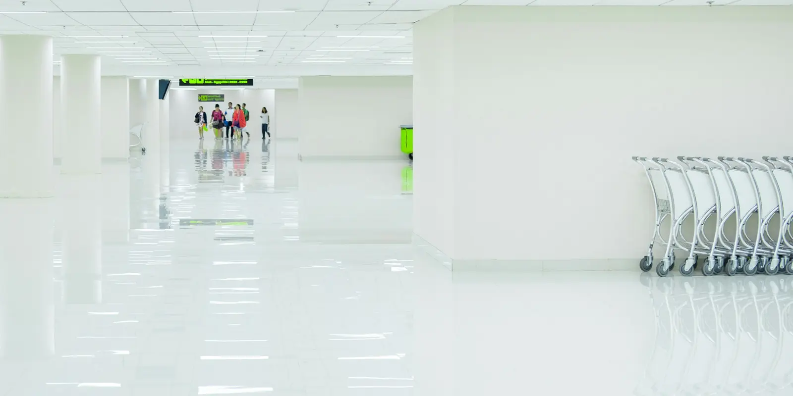 Travelers walking through a corridor inside Don Mueang International Airport's terminal