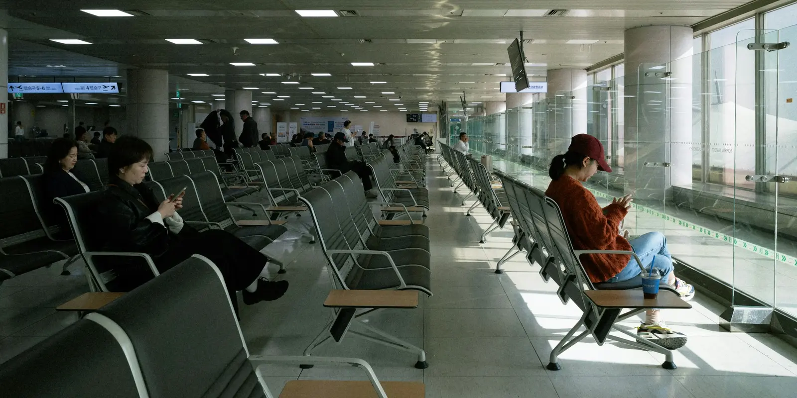 Traveler checking their phone in an airport lounge shortly after arrival