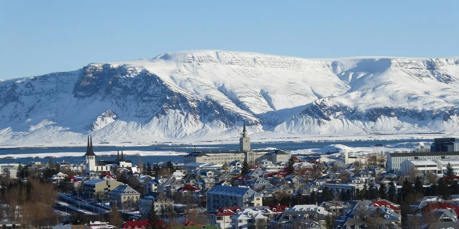 Aerial view of Reykjavík, Iceland, near snow-covered hills