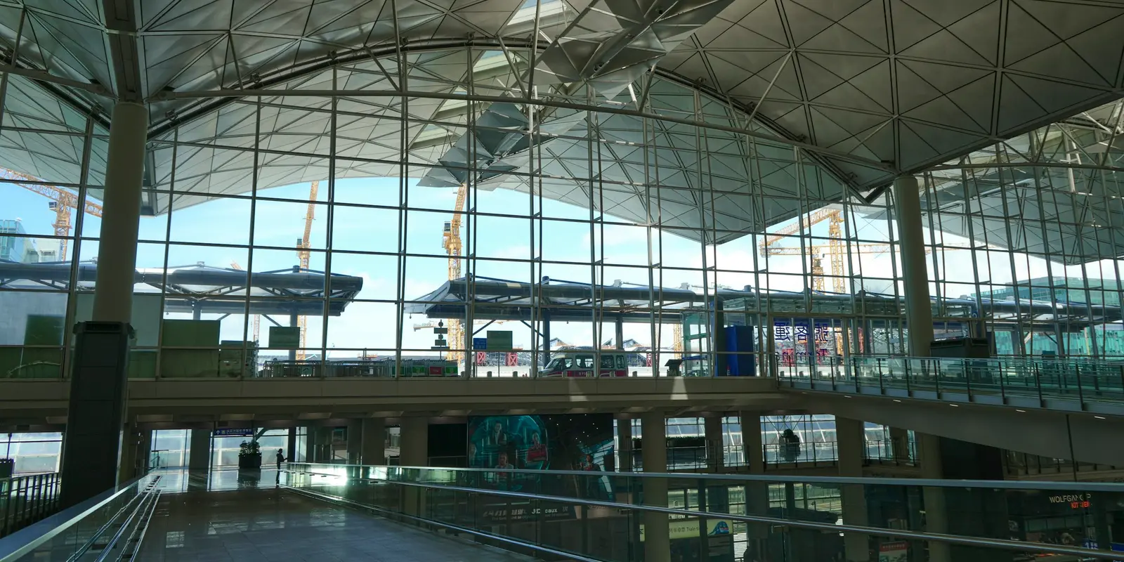 The glass-walled interior of a terminal building at Hong Kong International Airport