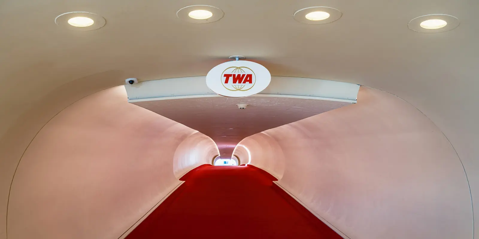 Inside the restored TWA Flight Center, now connected to JFK Terminal 5 Red-carpeted flight tube connecting the TWA Hotel to JFK's Terminal 5