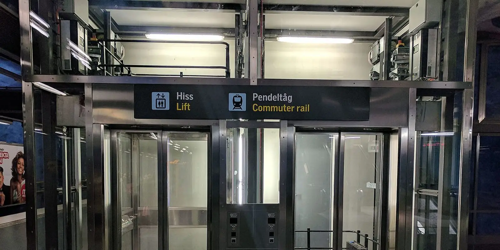 Lift and commuter-rail signs inside Stockholm City station
