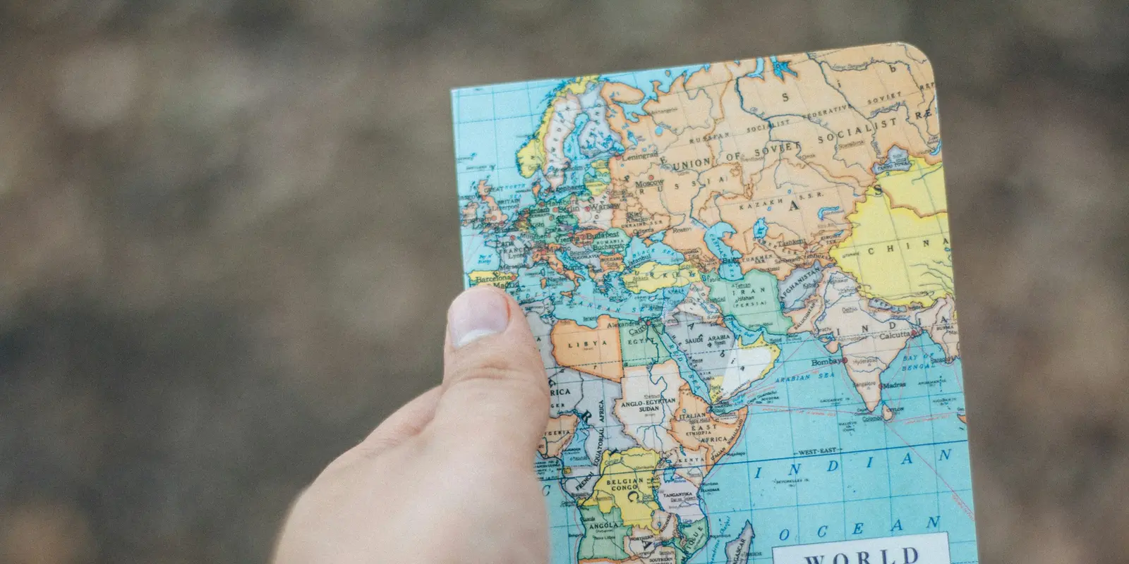 世界地図を手に、国境を越えるデータローミングを表現